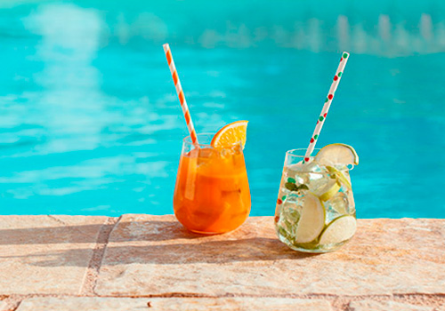 two cocktails on the edge of the pool